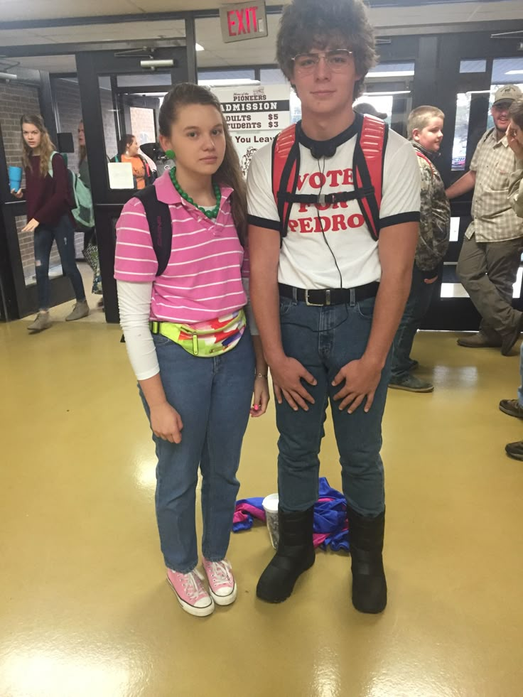 a young man and woman standing next to each other