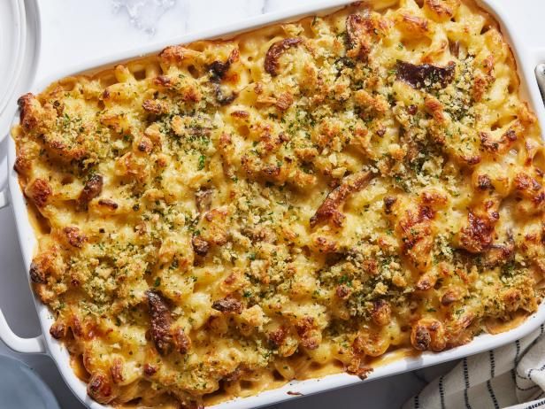 a casserole dish with meat and cheese in it on a white tablecloth