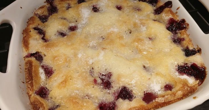 a casserole dish with cranberries and cheese