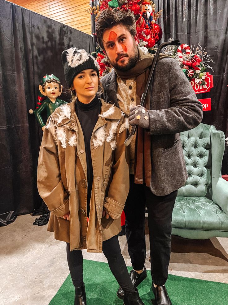 a man and woman standing next to each other in front of a green carpeted floor