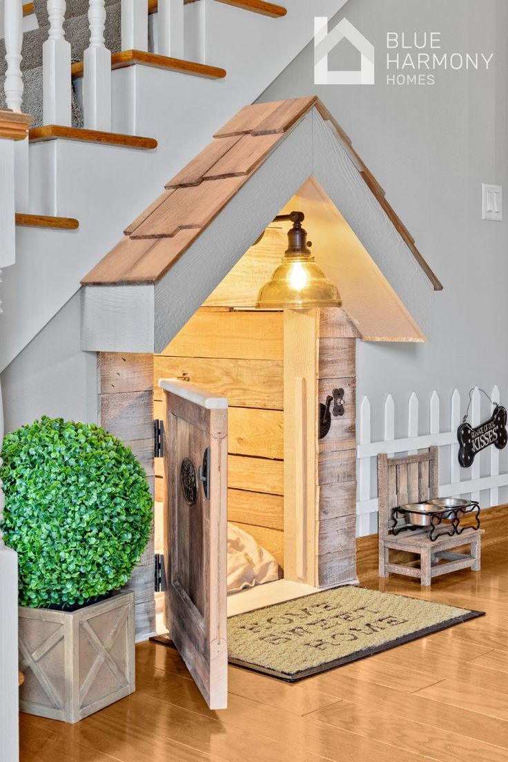 a dog house made out of pallets with stairs leading up to the second floor