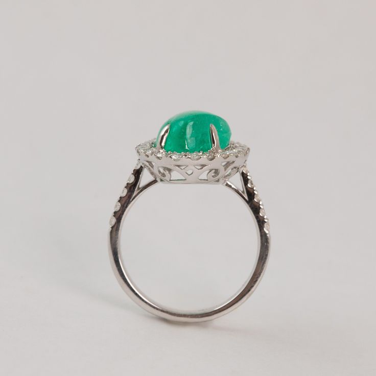 This buttery smooth cabochon emerald is wrapped snuggly in melee diamonds. Materials - 18k White Gold, Emerald, Diamond Weights - 5.17 Emerald, 0.60ct Diamond Size - 6.5 Formal Emerald Cabochon Diamond Ring, Luxury Emerald Cabochon Ring With Diamonds, Fine Jewelry White Gold Cabochon Emerald Ring, White Gold Cabochon Emerald Ring Fine Jewelry, Fine Jewelry White Gold Emerald Cabochon Ring, Elegant White Gold Cabochon Emerald Ring, Elegant White Gold Emerald Cabochon Ring, Luxury Cabochon Emerald Ring For Wedding, Luxury Emerald Cabochon Ring For Wedding