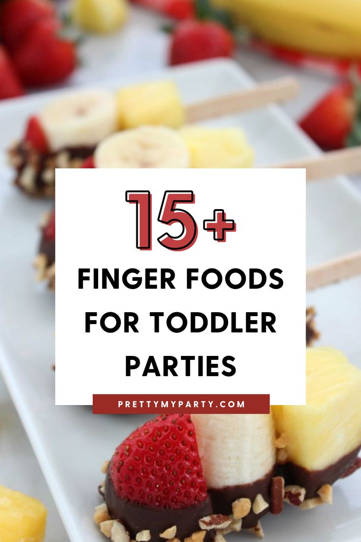 finger foods for toddler parties with strawberries, bananas and other fruit on skewers