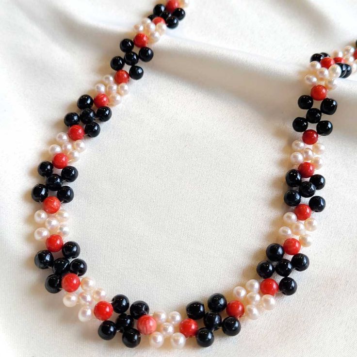 This elegant Coral, Pearl and Jade Necklace is the perfect accessory for any occasion. Delicately crafted with black jade, red coral, and freshwater pearls, this unique piece of jewelry is an eye-catching touch of sophistication to your look today! Black Jade (5mm) Red Coral (5mm) Freshwater Pearls (4mm) Goldfilled clasp Length: 15" Black Jade, Jade Necklace, Jade Jewelry, Red Coral, Fresh Water, Freshwater Pearls, Unique Pieces, Jade, Coral