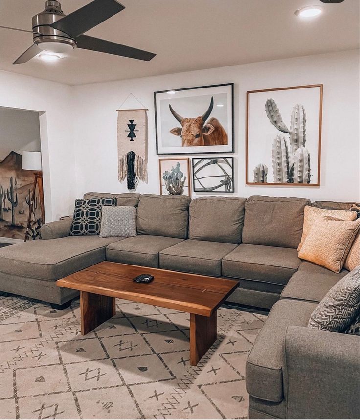 a living room filled with furniture and pictures on the wall above it's coffee table