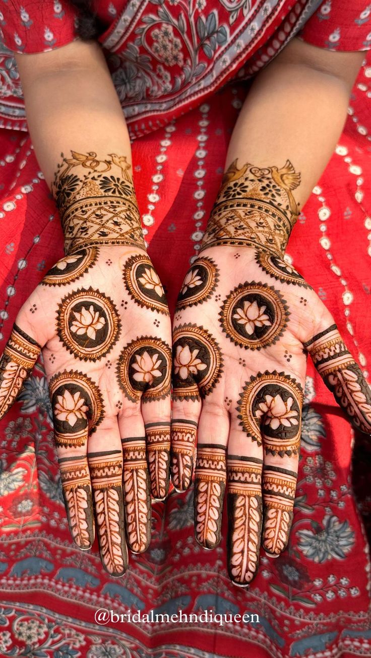 the hands of a woman with henna tattoos