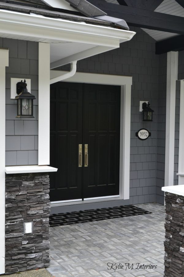 a black front door on a gray house