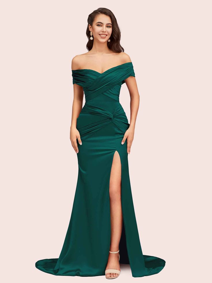 a woman in a long green dress with a slited skirt and thigh high heels