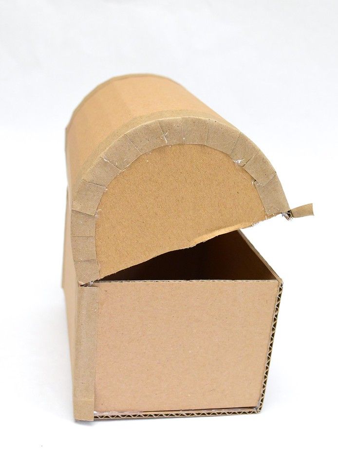 an open cardboard box sitting on top of a white surface with the lid partially closed