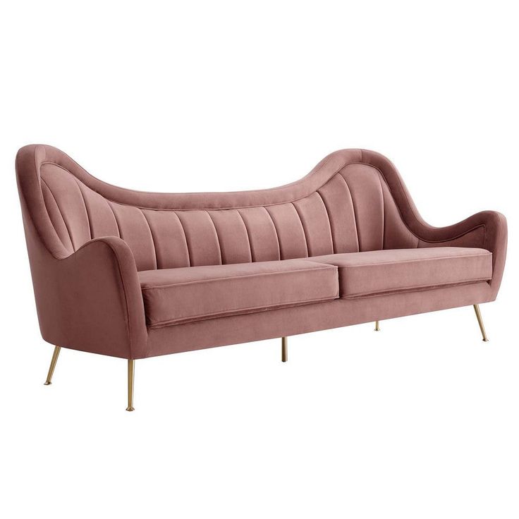 a pink velvet couch with gold legs