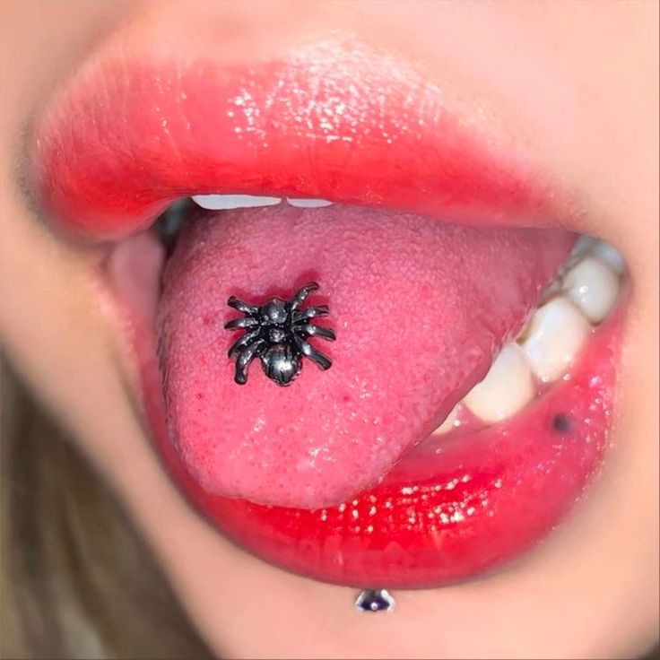 a woman's tongue with a spider on it