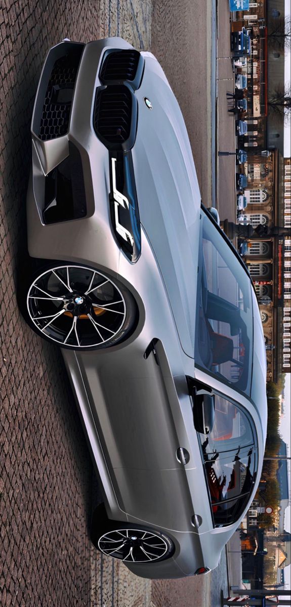 an aerial view of a silver sports car parked on the side of a brick building