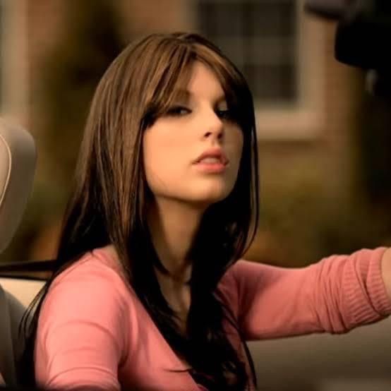 a woman sitting in the driver's seat of a car