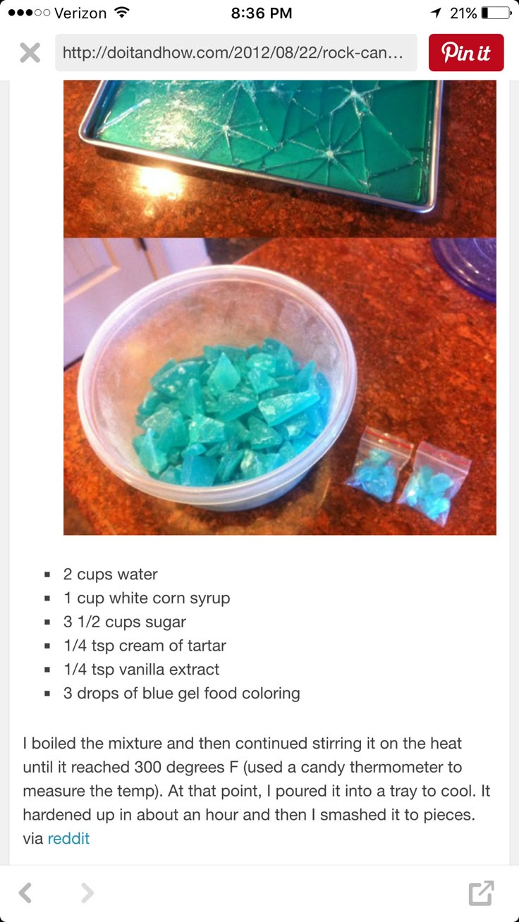 a bowl filled with blue and green rocks on top of a wooden table next to a tray