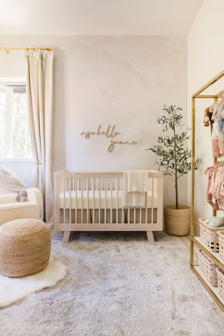 a baby's room with a crib, chair and rug