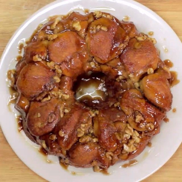 a bundt cake covered in nuts on a white plate