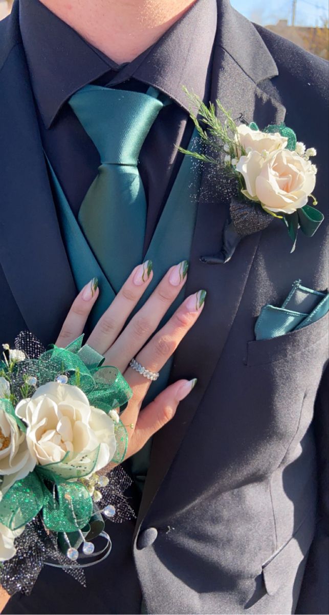 a man in a suit and tie with flowers on his lapel flower bouquets