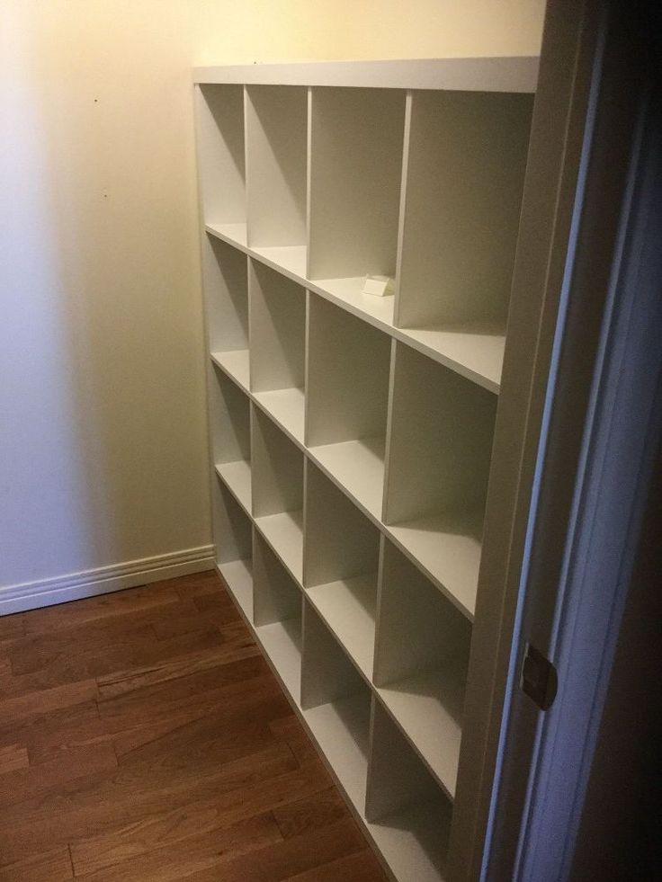 an empty bookcase in the corner of a room