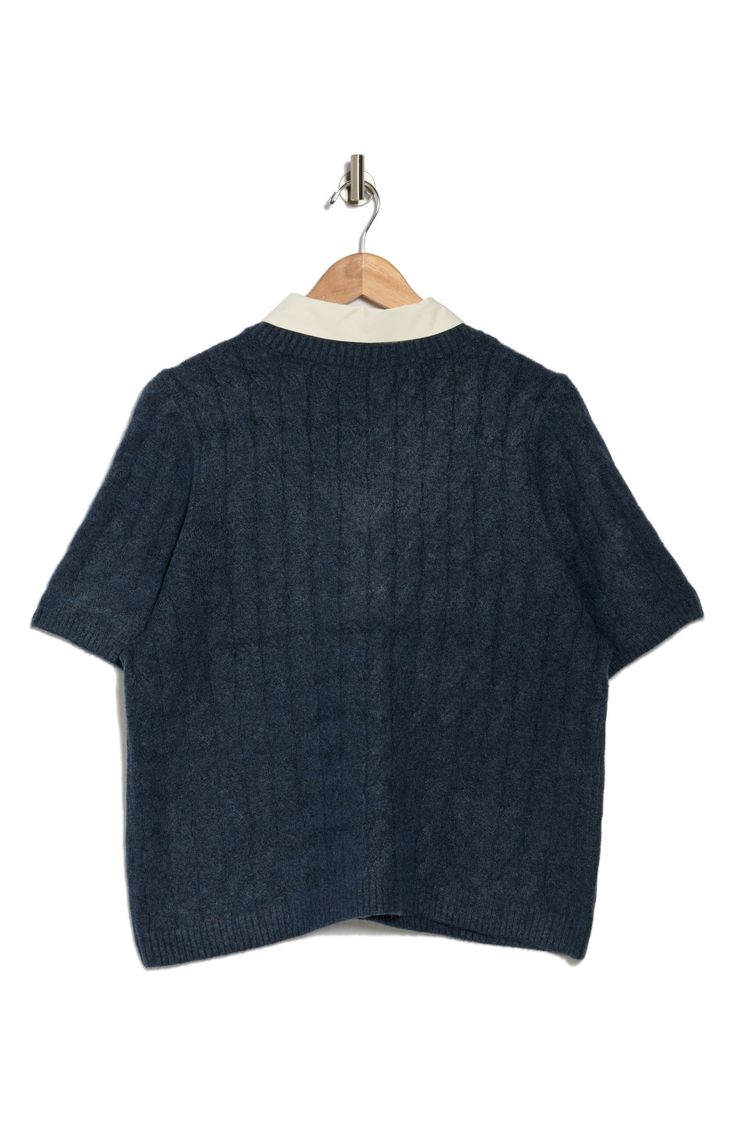 This cable-stitched sweater is contrasted by a woven collar in this twofer top that elevates in-office or off-duty looks. 19 1/2" length Point collar Short sleeves 73% acrylic, 24% polyester, 3% spandex Machine wash, tumble dry Imported Blue Polo Sweater With Ribbed Collar For Work, Navy Top With Contrast Collar For Workwear, Navy Ribbed Collar Top For Work, Navy Tops With Ribbed Collar For Work, Knit Polo Sweater For Work, Blue Collared Polo Sweater For Workwear, Collared Textured Knit Sweater For Work, Blue Sweater With Ribbed Collar For Work, Casual Collared Cable Knit Top