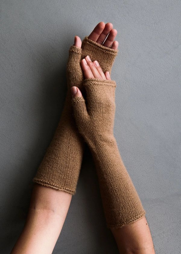 two hands with brown knitted arm warmers