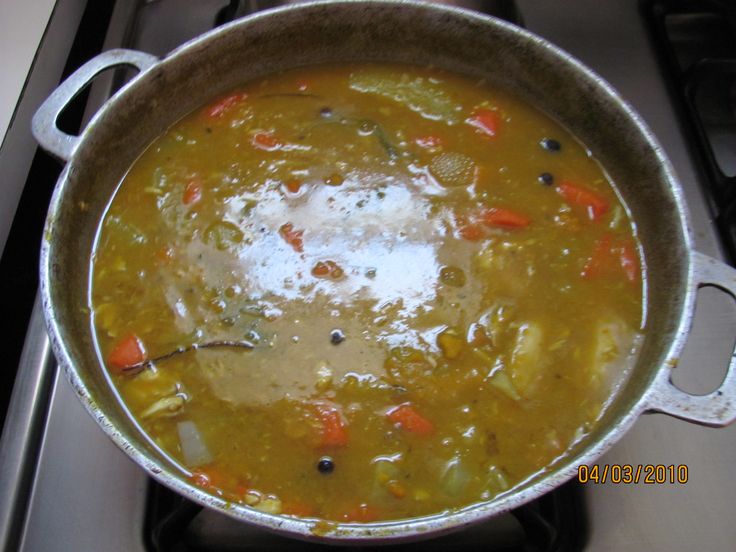 a pot filled with soup sitting on top of a stove