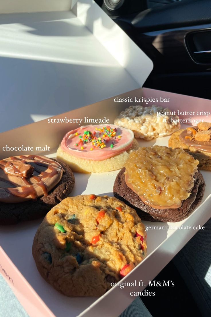 an assortment of cookies and desserts on a tray in a car's dashboard