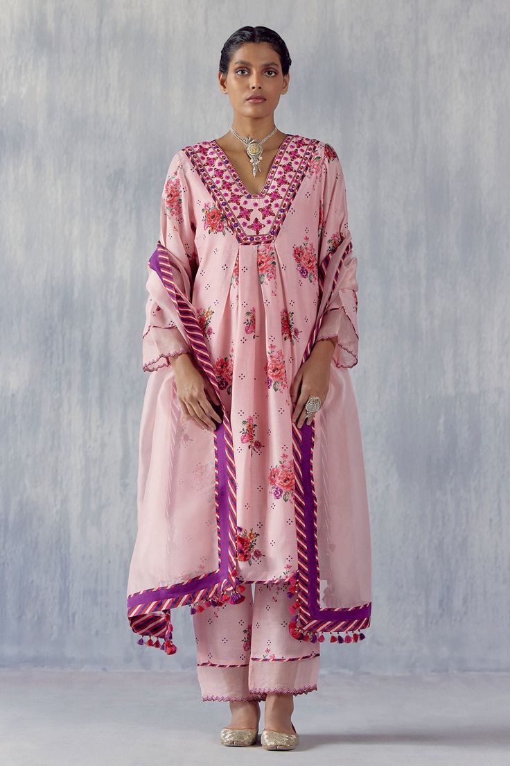 Peach cotton silk kurta with floral print, including thread and mirror cutwork embroidered neckline. Comes with pant, a slip, and a silk organza dupatta having handmade tassels and multi-colored candy striped print.
Component: 4
Pattern: Printed, Embroidered
Type Of Work: Floral, Striped, Thread, Mirror cutwork
Neckline: V Neck
Sleeve Type: Full
Fabric: Cotton silk, Dupatta : Silk organza
Color: Peach, Multi Color
Other Details: 
Side slits
Kurta Length : 44 inches
Occasion: Mehendi and Haldi, P Designer Kurta, India Wedding, Kurta Style, Organza Dupatta, Embroidered Neckline, Pakistani Dress Design, Silk Organza, Indian Designer, Kurta Designs