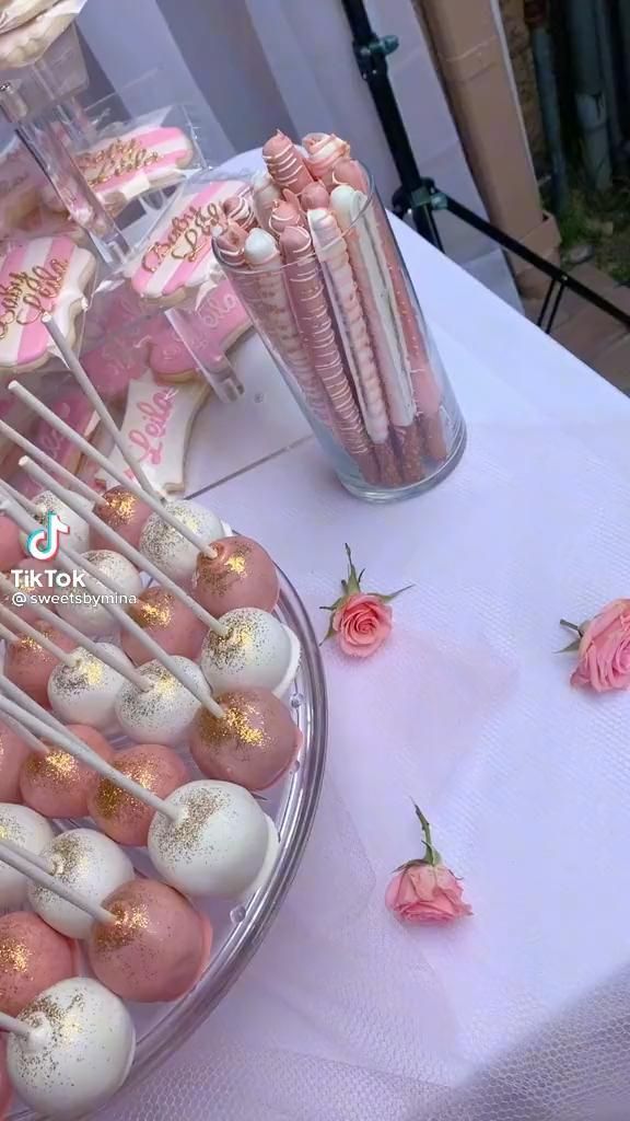 pink and white desserts are displayed on a table