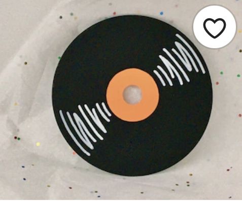 a black record with an orange disk on it and a heart above the disc that says i love vinyl records