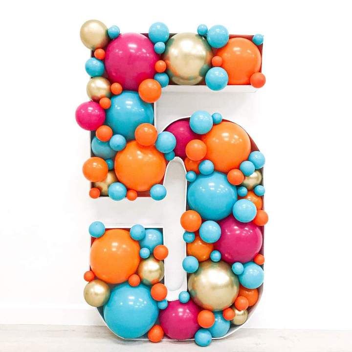 the letter e is made up of balloons and balls in different colors, including blue, orange, pink, yellow