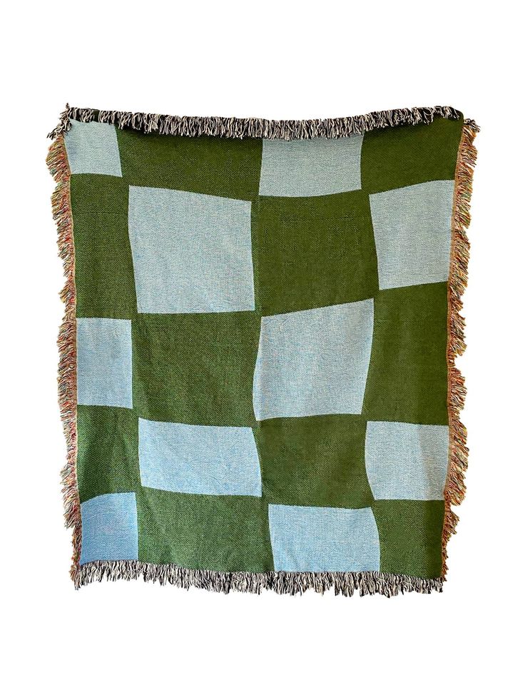 a green and white checkered blanket with fringes on the edges, against a white background