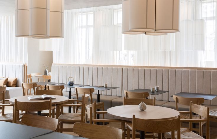 an empty restaurant with wooden tables and chairs