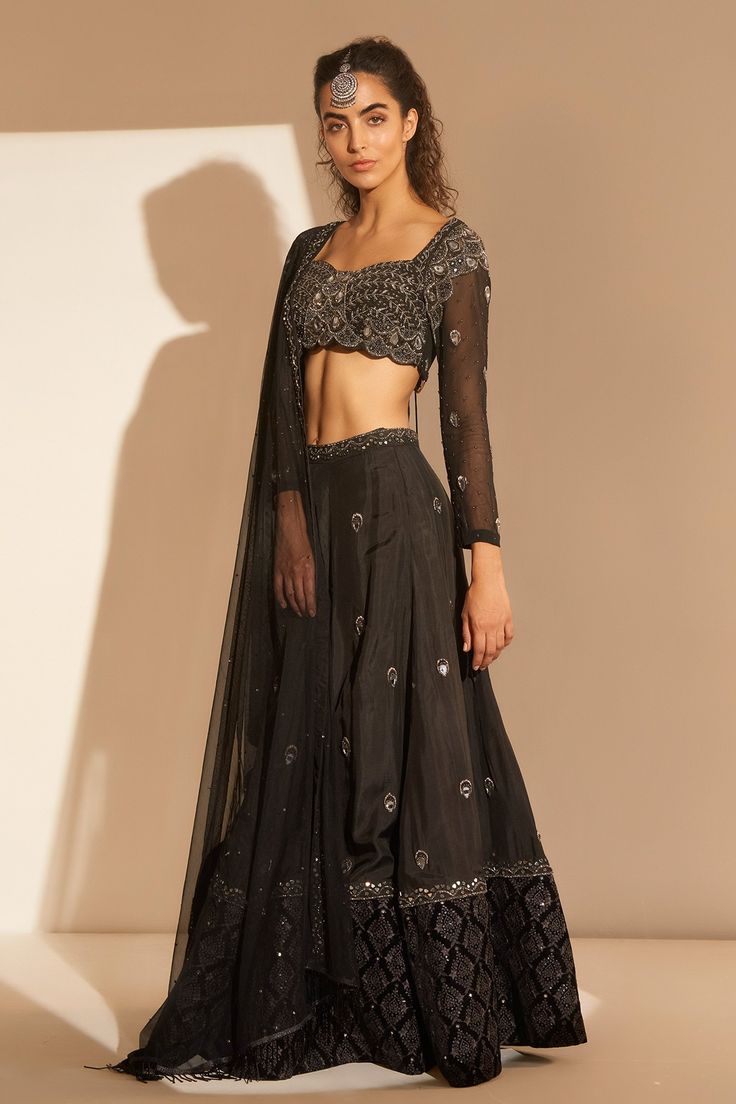 Black silk lehenga with attached cancan and beads embroidery. Comes with embroidered blouse and dupatta.
Component: 3
Pattern: Embroidery
Type Of Work: Beads
Neckline: Sweetheart
Sleeve Type: Sheer
Fabric: Silk
Color: Black
Other Details: 
Tassel details
Embroidered waistband
Attached lining
Approx weight (in kg) : 1.75
Occasion: Sangeet - Aza Fashions Festive Dupatta With Intricate Embroidery For Evenings, Festive Evening Dupatta With Intricate Embroidery, Silk Sharara With Sheer Dupatta For Evening, Anarkali Style Palazzo Set With Mirror Work For Evening, Evening Embroidered Traditional Drape Sets, Diwali Evening Salwar Kameez With Resham Embroidery, Festive Embroidered Anarkali Set For Evening, Bollywood Style Organza Evening Sets, Semi-stitched Evening Sets With Sheer Dupatta