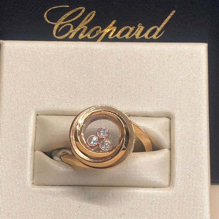 18 Karat Rose Gold Chopard Ring With A Weight Of 5.80 G. The Ring Contains Three Diamonds With A Weight Of 0.15 Carats. Size 6.25 Yellow Gold Diamond Rings With Rotating Bezel, Luxury Rings With Rotating Bezel For Formal Occasions, Luxury Gold Rings With Rotating Bezel, Luxury Rings With Rotating Bezel For Gift, Luxury Rings With Rotating Bezel As Gift, Luxury White Gold Rings With Rotating Bezel, Aaa Quality Luxury Diamond Ring For Formal Occasions, Classic Formal Ring With Rotating Bezel, Elegant Anniversary Ring With Rotating Bezel