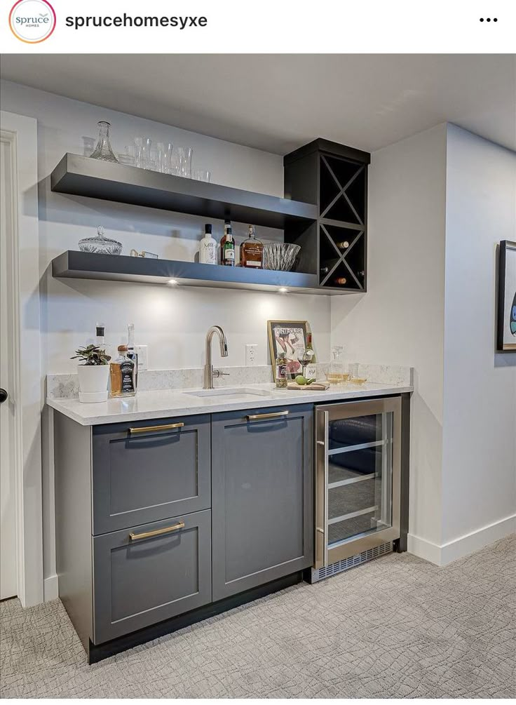 a kitchen with gray cabinets and white counter tops