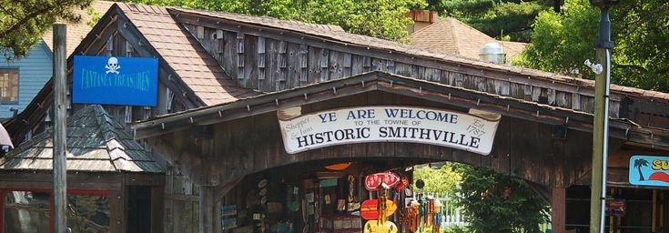 the entrance to historic smethvillee is decorated with wooden signs and hanging decorations