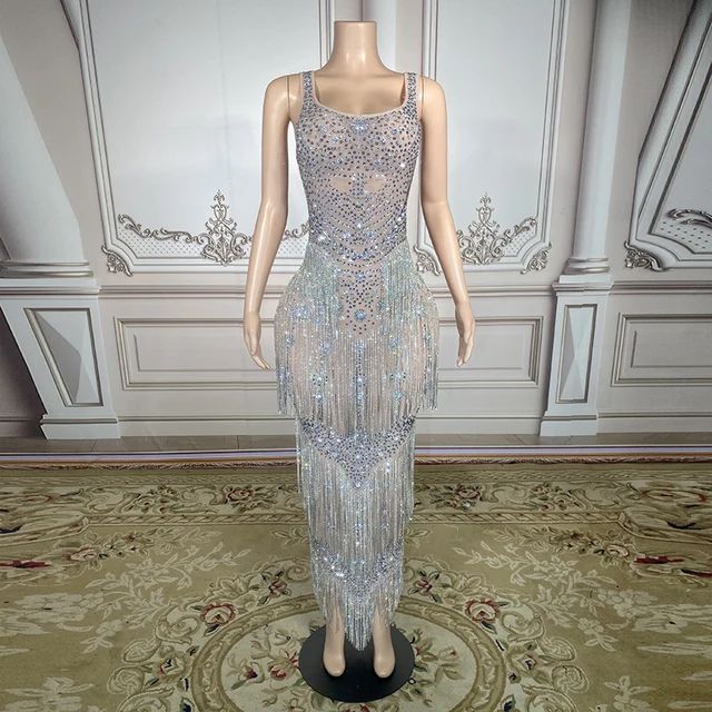 This Maxi Rhinestones Stones Dress is a stunning piece of clothing. It is made with Women`s crystals and Rhinestone, and is plated with Silver Plated, Plated, and Alloy. It is perfect for any special occasion, such as an anniversary or a party. This dress is truly innovative, with its unique design and intricate details. It is sure to make you stand out in any crowd. Plus, it is made to order, so you can be sure that it will fit you perfectly. Please note that this is a made to order item and wi Elegant Dresses With Sequins For Glamorous Events, Glamorous Sequin Dress With Rhinestone Fringe For Evening, Glamorous Silver Sequin Dress With Rhinestones, Elegant Sequin Dress For Glamorous Events, Glamorous Floor-length Evening Dress With Rhinestone Fringe, Elegant Rhinestone Dress For Glamorous Events, Cocktail Evening Dress With Rhinestones And Floor-length, Luxury Embellished Evening Dress For Glamorous Events, Sleeveless Dresses With Rhinestone Fringe For Wedding