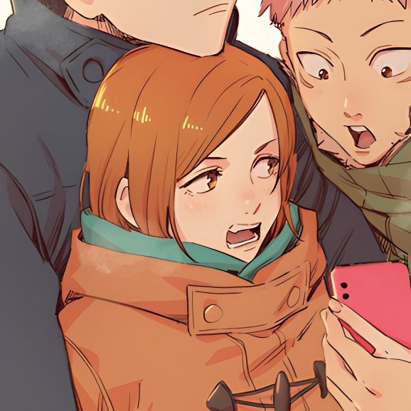 three people standing next to each other looking at a cell phone and making funny faces