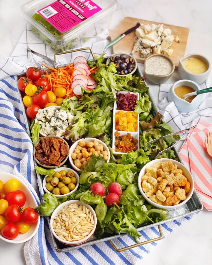 a table filled with different types of food and dipping sauces on top of it