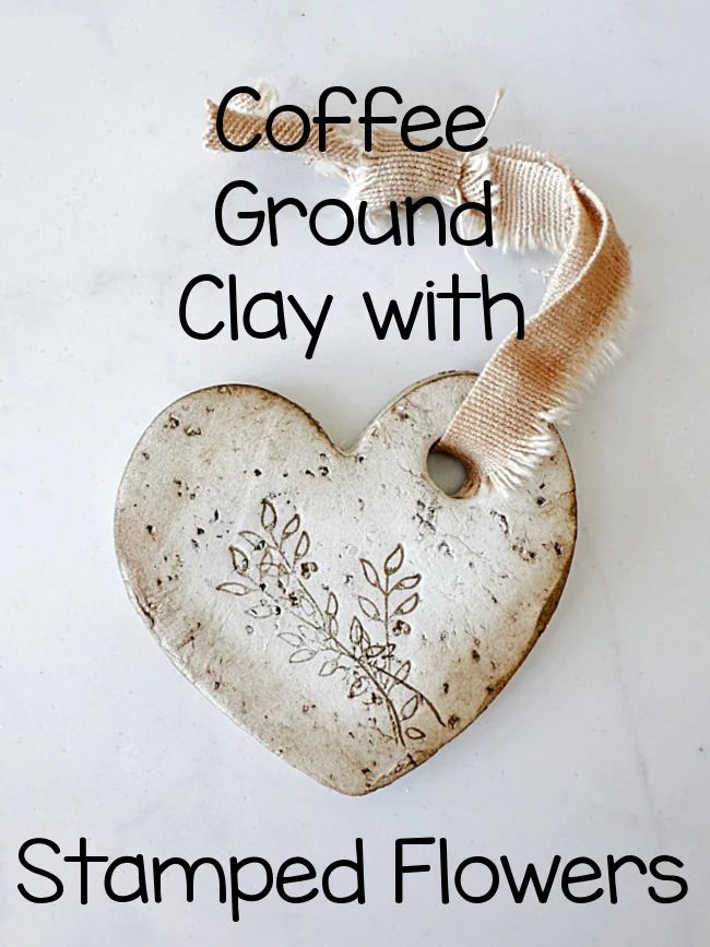 coffee ground clay heart with stamped flowers on it and the words, coffee ground clay with stamped flowers on it