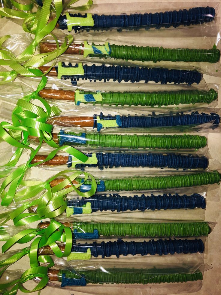 several green and blue toothbrushes in plastic wrapped in cellophane with bows