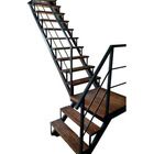 a metal and wood staircase with handrails