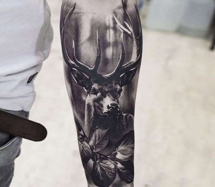 a man with a deer tattoo on his arm