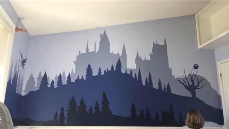 a child's room with a castle painted on the wall