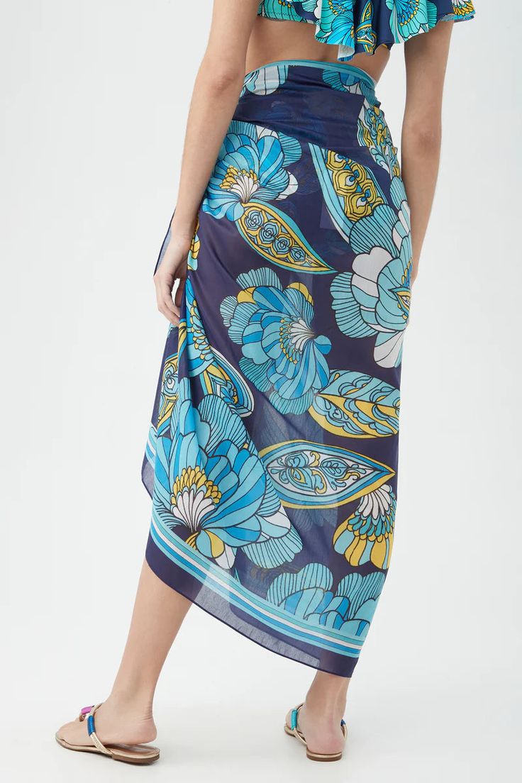 Indulge in a burst of vibrant hues with this trendy cover-up made of airy rayon crepe. Perfect for any resort vacation, this printed sarong is a must-have island accessory. Pro tip: transform this versatile piece into a top, dress, or skirt for a versatile 3-in-1 look that screams vacation! Measures: 45" x 66" Bohemian Printed Sarong For Pool, Multicolor Tropical Print Sarong For Vacation, Multicolor Tropical Print Sarong For Pool, Multicolor Printed Sarong For Beach Cover-up, Beachy Multicolor Printed Sarong, Vibrant Print Beachwear Sarong For Vacation, Multicolor Floral Print Beach Sarong, Vibrant Print Sarong For Beach Season, Beachwear Sarong With Vibrant Print For Vacation