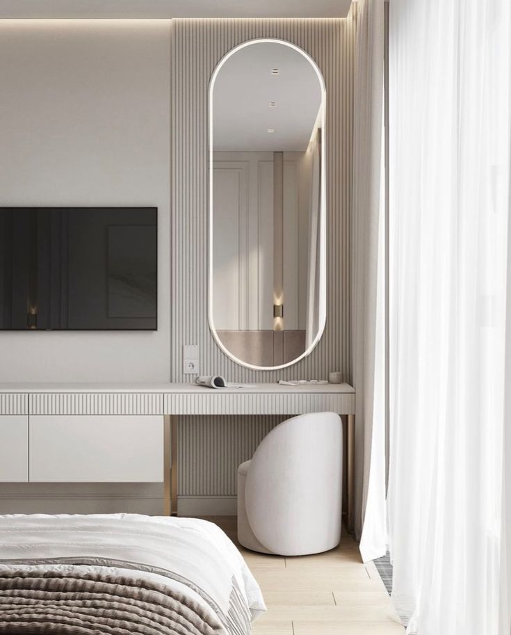 a bedroom with a large mirror on the wall and a bed in front of it