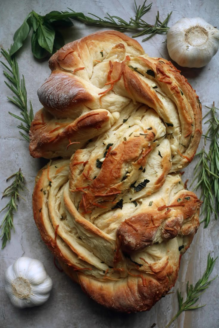 garlic bread with herbs and garlic on the side, next to garlic cloves