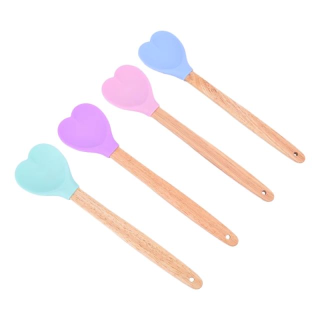 three wooden spoons with hearts on them and one is blue, the other has pink