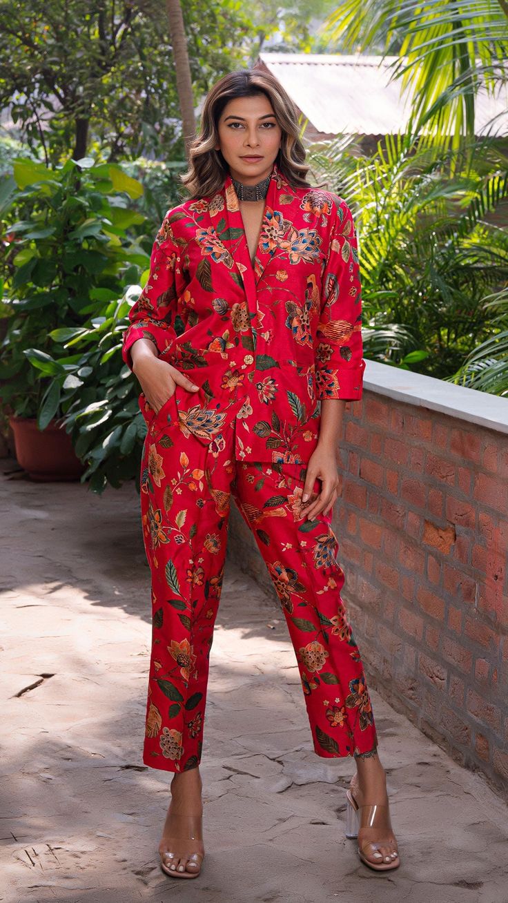 Make heads turn with out printed co-ord set in silk. Straight Pants with Blazer Jacket. Made in printed raw silk. Color : Red. Fully lined. No of Components : 2. Model height is 5.6” and is wearing a size S. Wash Care : Dry Clean Only. Red Silk Sets With Printed Motifs, Red Silk Sets For Summer, Silk Sets With Printed Motifs For Workwear, Red Silk Summer Set, Silk Workwear Sets With Printed Motifs, Red Silk Sets With Floral Print, Silk Red Sets With Floral Print, Red Cotton Sets With Floral Print, Red Cotton Floral Print Sets