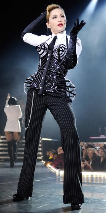 a woman in black and white outfit on stage